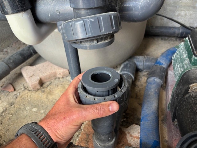 démontage d'une vanne sur le système de filtration par le technicien ADN recherche de fuite piscine
